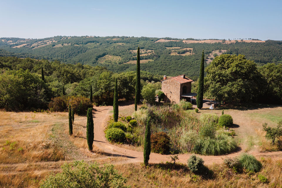 Stone-built villa surrounded by terraced gardens and valley views.